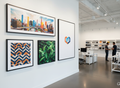 SEG Wall Art with black aluminum frame and vibrant fabric graphics in modern office and retail setting
